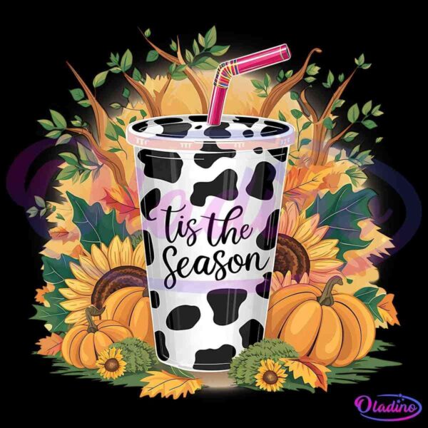 A festive fall-themed image features a cow-print cup with a pink and yellow striped straw, surrounded by pumpkins, sunflowers, and autumn leaves. The cup has the words "tis the season" written on it in black script.